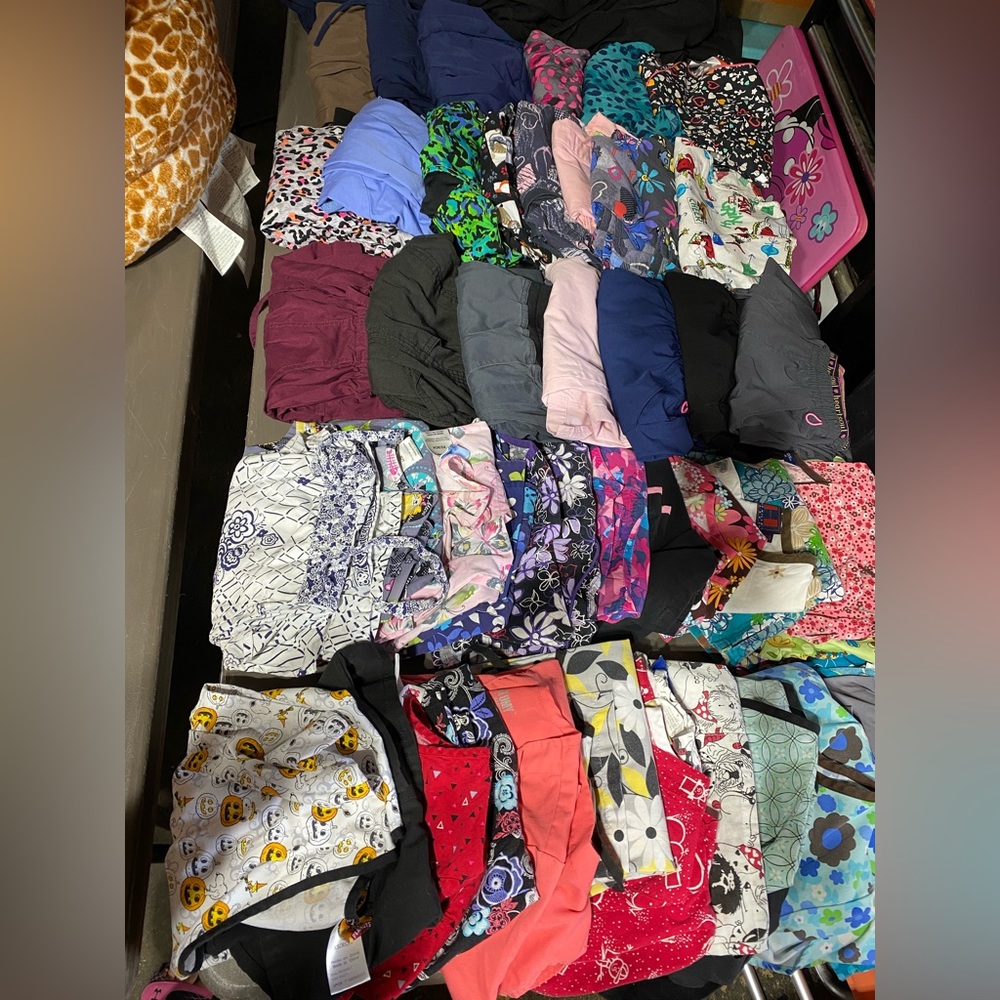 31 scrub tops, 10 pairs of scrub pants and 3 scrub jackets all different bands.
